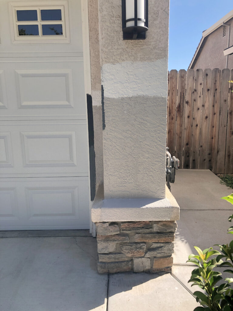 Sherwin Williams Versatile Gray on exterior with stone on stucco. Kylie M Edesign paint color expert