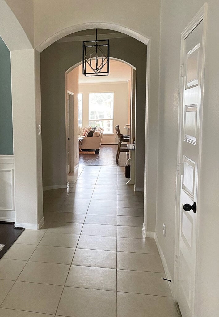 Beige off white tile in hallway, arched doorway, Benjamin Moore Edgecomb Gray lightened 25