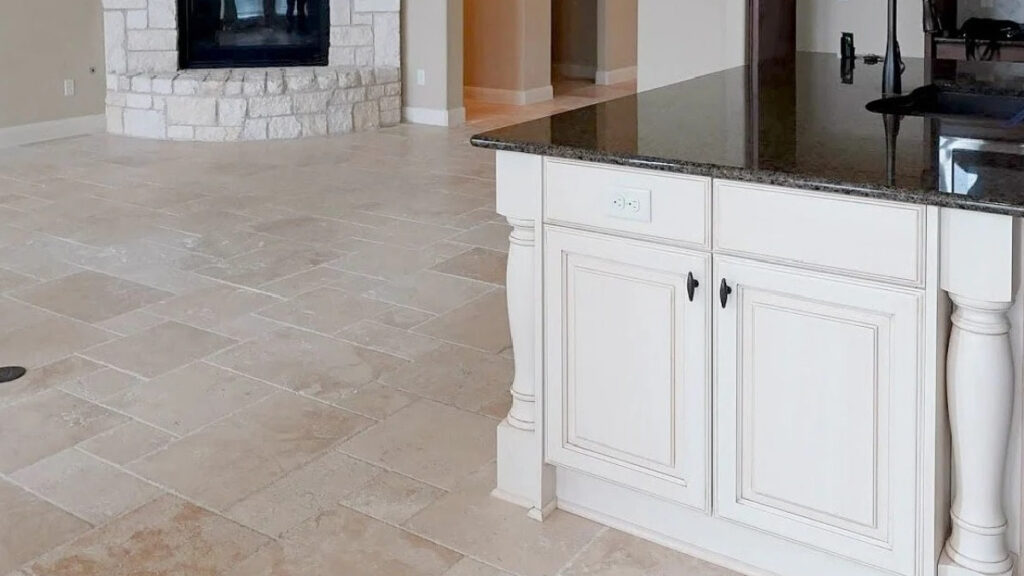 Sherwin Williams Antique White kitchen island cabinet with travertine tile flooring