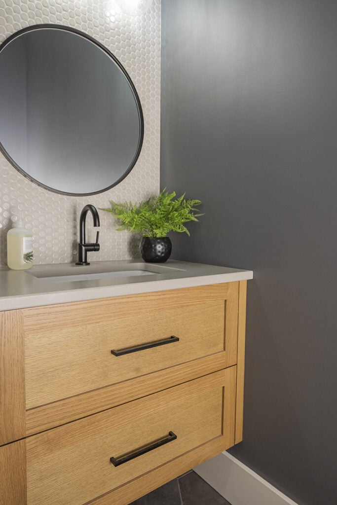 Small bathroom or powder room. Black fixtures, concrete look countertop, penny tile, gray hexagon floor tile. Benjamin Moore Stormy Sky best dark gray color. Kylie M Edesign
