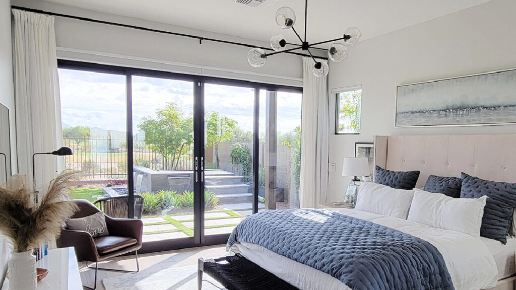 Benjamin Moore Silver Satin is simila to Dunn Edwards Faded Gray, shown in bedroom with gray-blue linens and decor