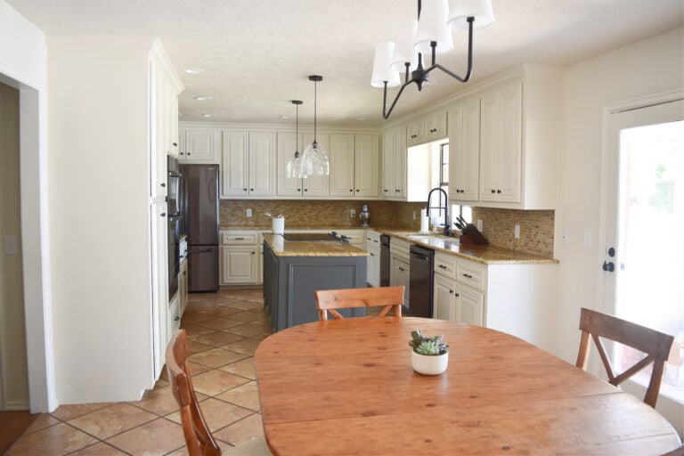 Kitchen remodel painted wood cabinets, Sherwin Williams Moderate White, travertine, orange tile floor, granite countertop, black stainless steel appliances. Ashwood Moss