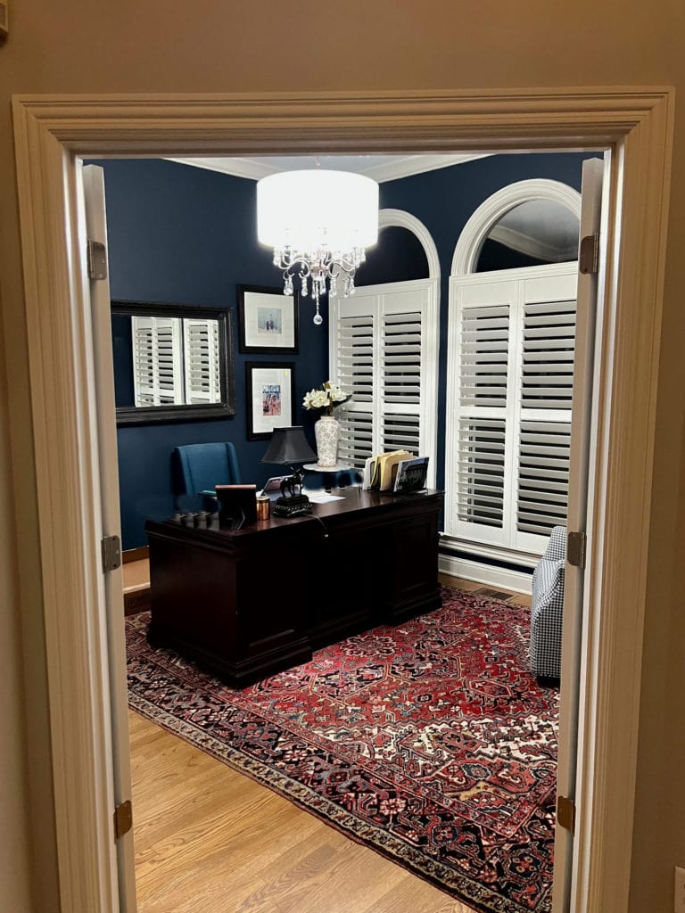 home office with Benjamin Moore Hale Navy walls, white trim and wood flooring