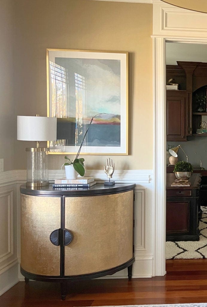 Sherwin Williams Creamy trim, wainscoting, gold paint color similar to Harmonic Tan, home decor in foyer