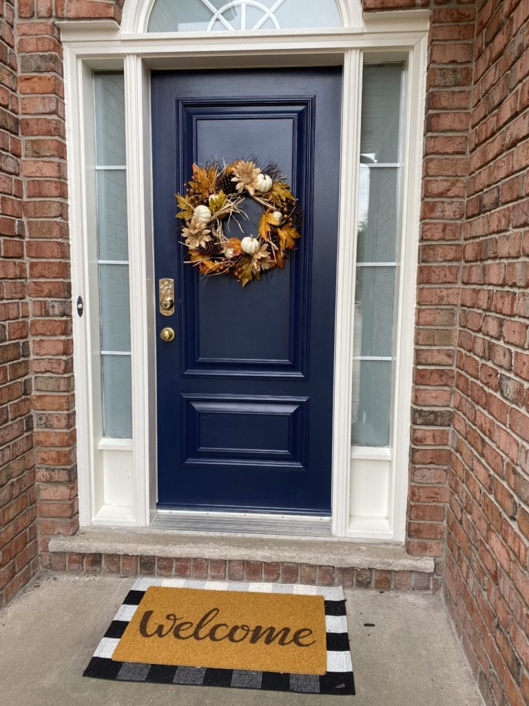 Sherwin Williams Naval blue front door with pink exterior brick