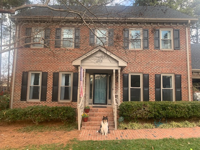 Sherwin Williams Riverway painted front door with red orange brick exterior, Sherwin Williams Keystone Gray trim color. Kylie M Edesign