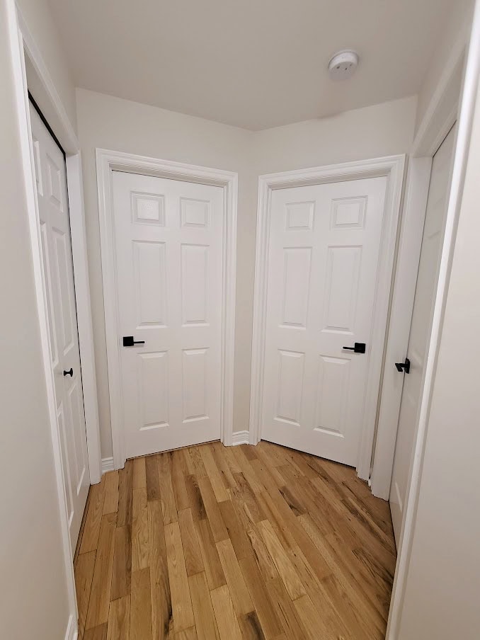 Sherwin Williams White Heron off white paint colour with yellow oak wood flooring, white trim like Pure Whiter