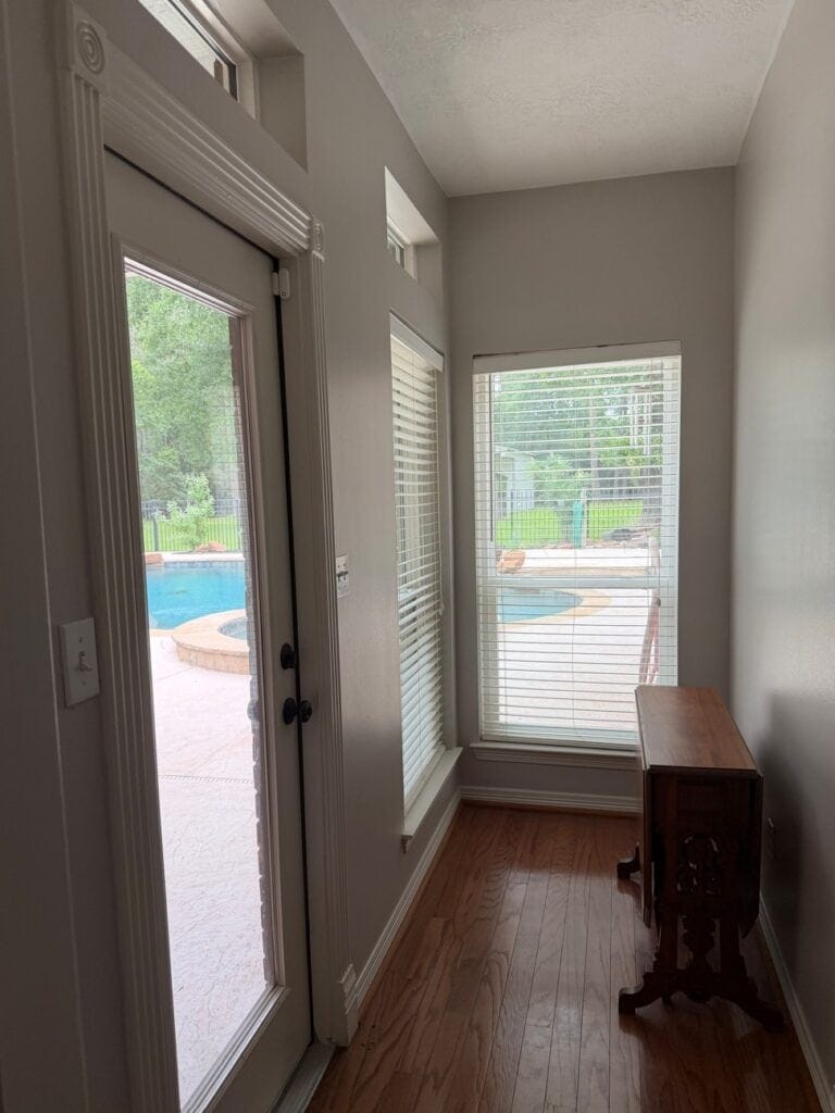 Behr Chic Gray in entryway with red stained wood flooring and natural light