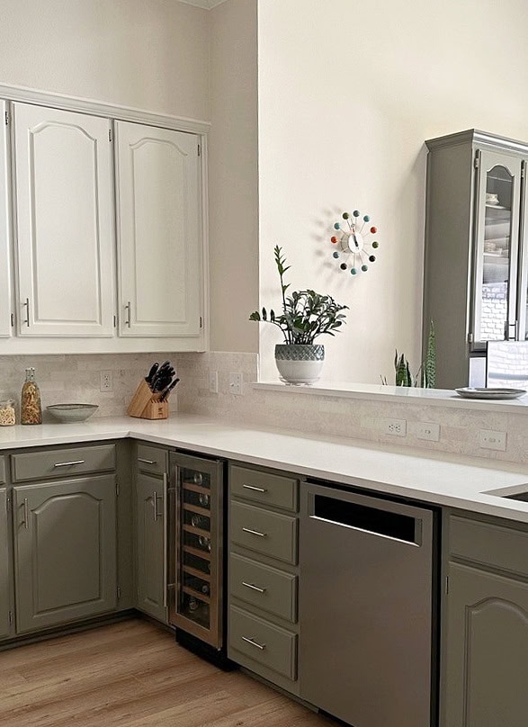 kitchen peninsula, 2 color cabinet palette, uppers lowers, White Dove, Antique Pewter, Maritime White beige walls. Frosty Carrina countertop