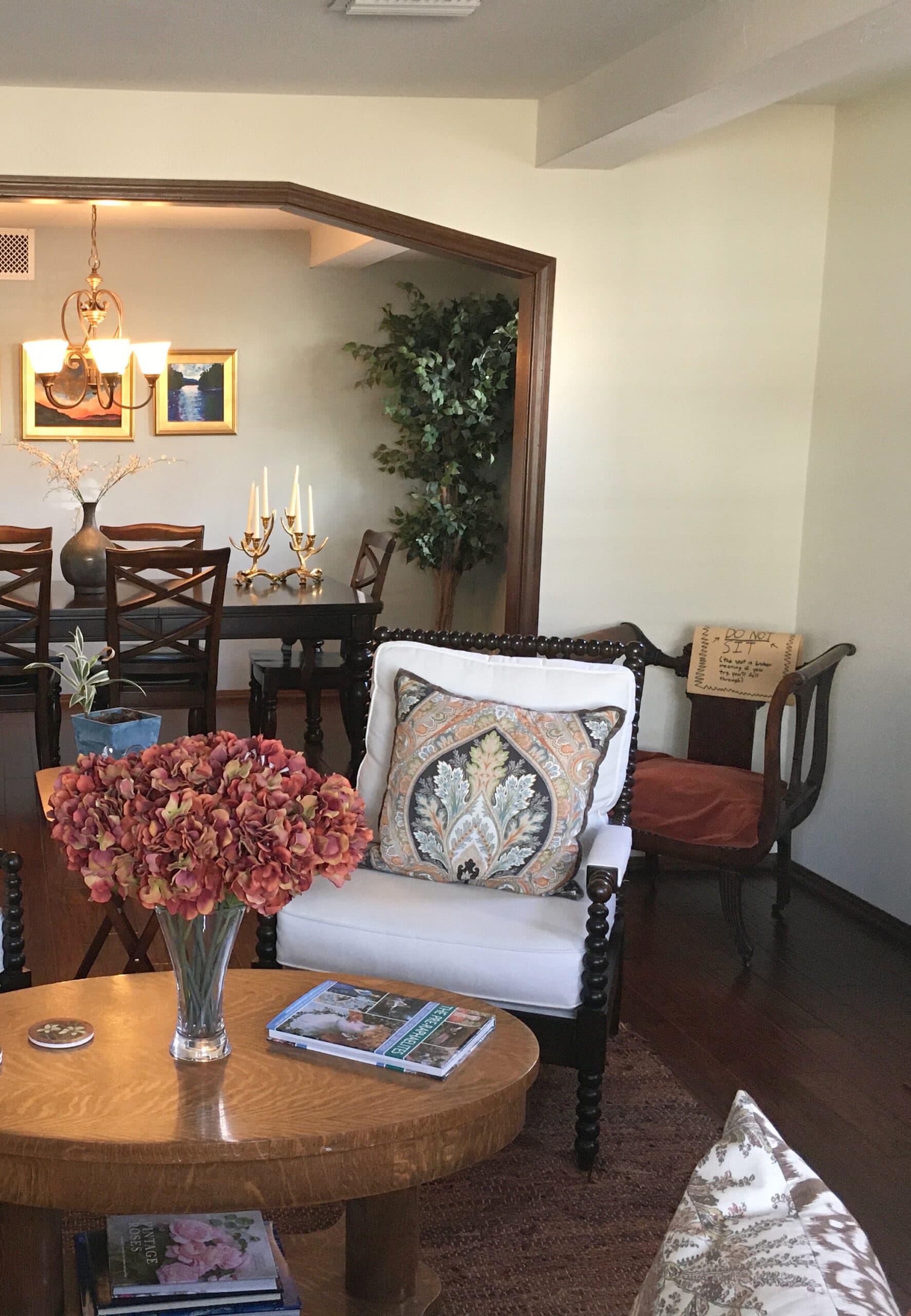Benjamin Moore Antique White, off-white cream paint color, dark wood trim, dark floor and furniture, arched opening to dining room. Kylie M client photo