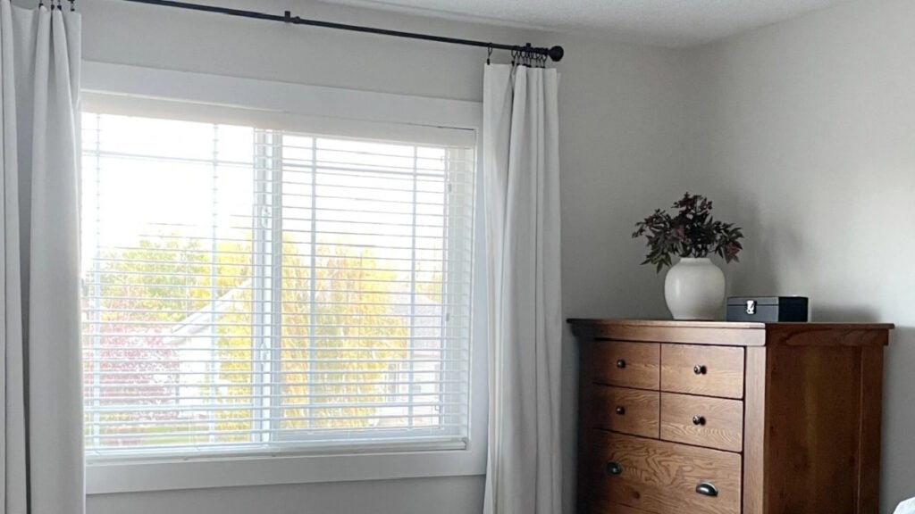 Benjamin Moore Classic Gray in bedroom with natural light and wood furniture