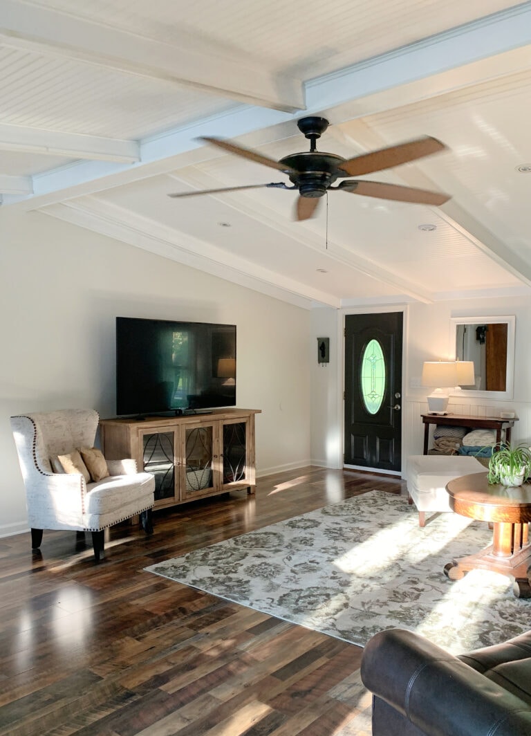 Sherwin Williams White Duck in living room low vaulted ceiling with white painted tongue and groove, beams, black front door. Kylie M Edesign