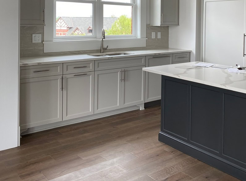 Iron Ore kitchen island, painted cabinets in greige, Sherwin Williams Agreeable Gray, white quartz countertop, subway tile,