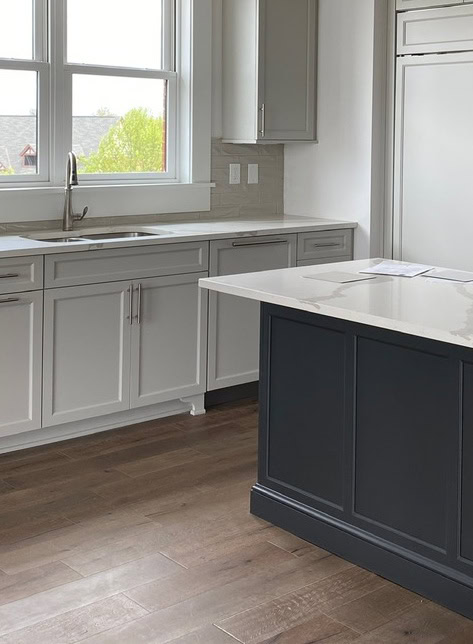 Kitchen island cabinets painted soft black Sherwin Iron Ore, white quartz countertop, Sherwin Agreeable Gray greige painteed cabinets and subway tile, kitchen update