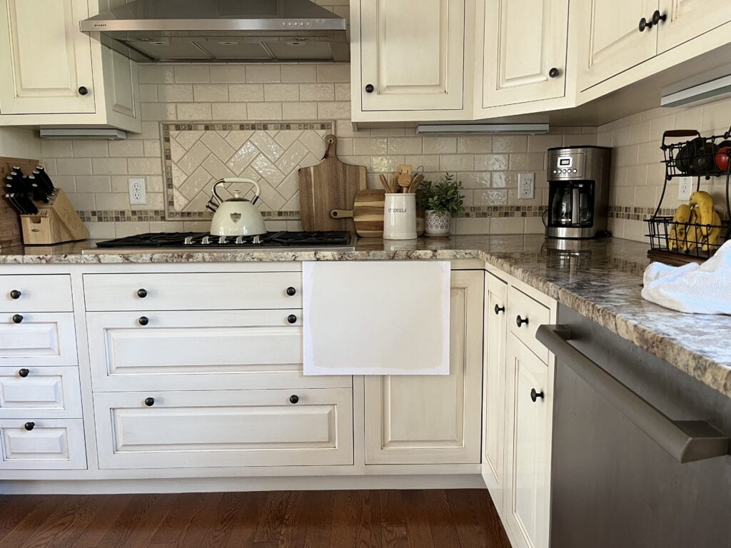 Benjamin MOore White Dove 25 percent darker with warm granite countertops on cabinets