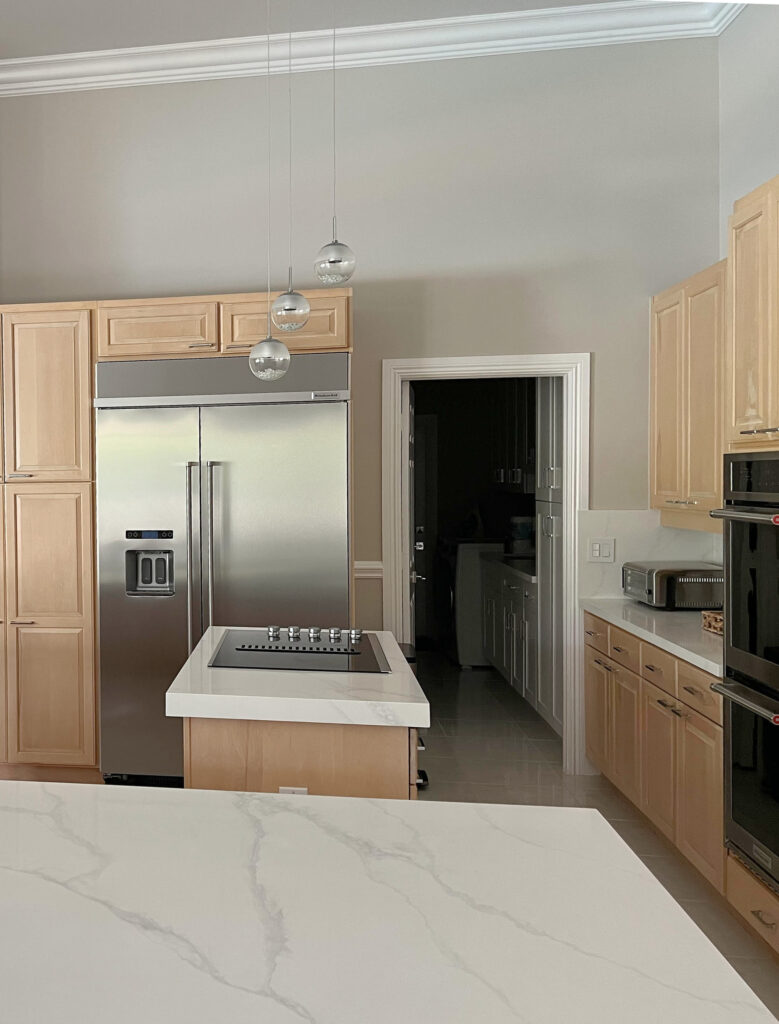 Calacatta Mist white quartz marble look countertop, Sherwin Williams Modern Gray paint color light maple wood cabinets.