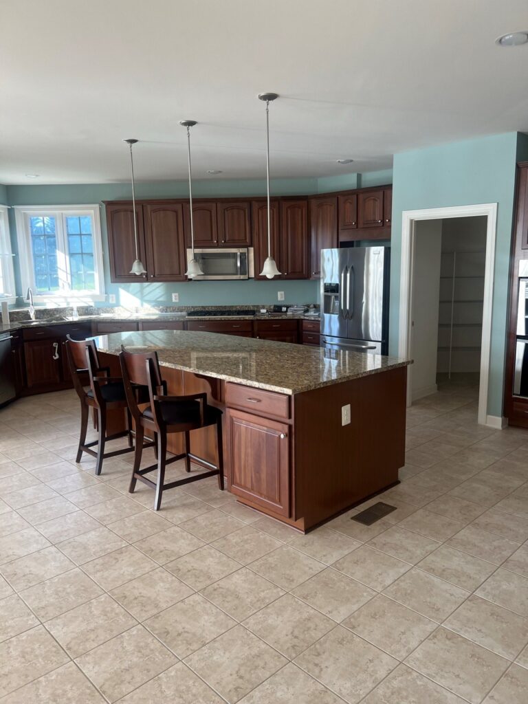 Cherry kitchen cabinets before painting, beige tile floor