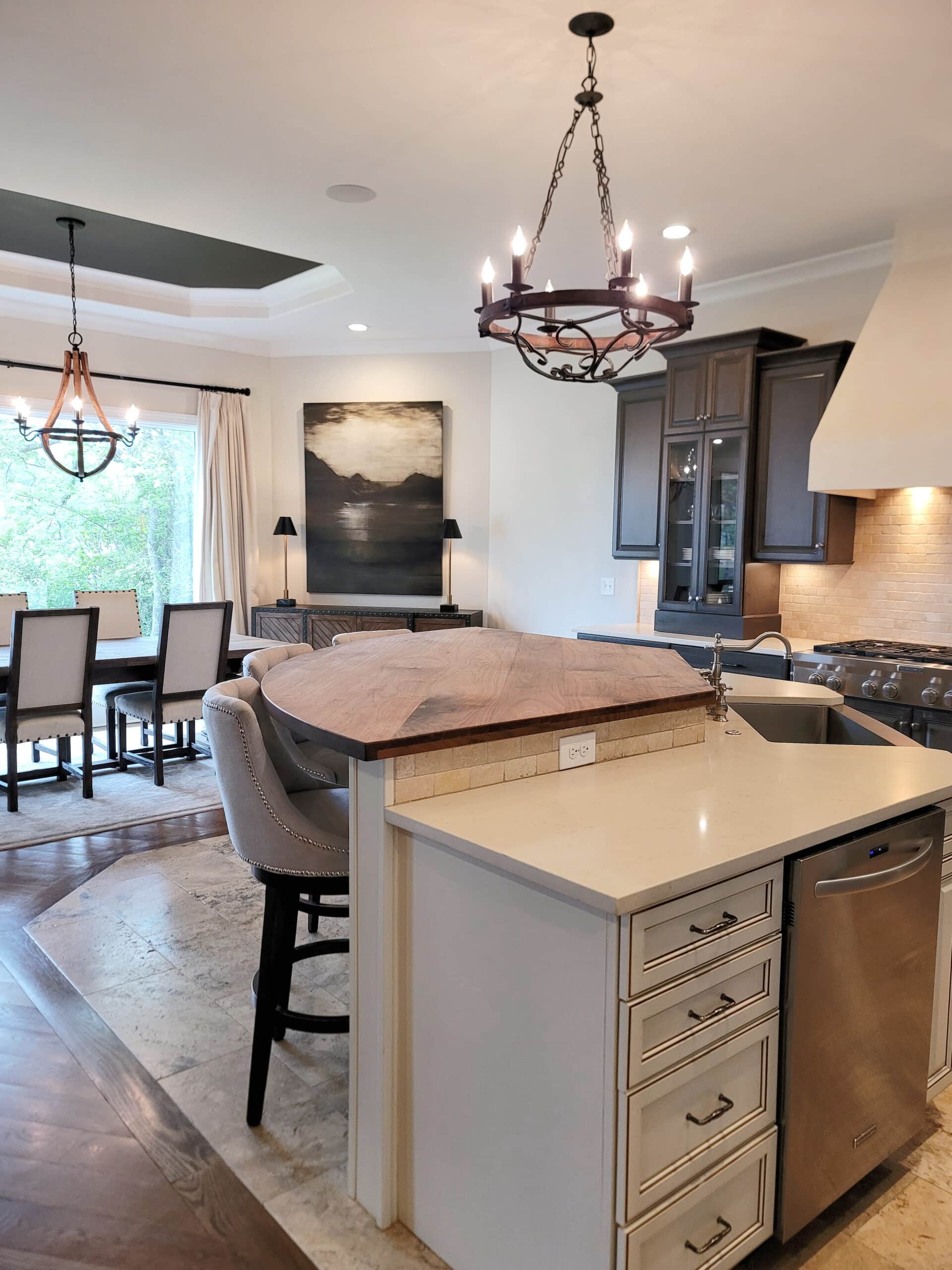 Cream painted island cabinets, glazed, travertine tile floor, walls Benjamin Moore Winds Breath match, dark wood cabinets. Raised wood island top.