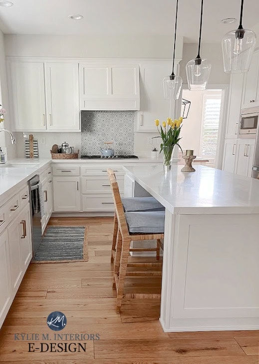 Kitchen update, painted white cabinets, Sherwin Williams Pure White Vadara White Aura quartz. subway tile, wood floor, rattan island stools. Kylie M Edesign