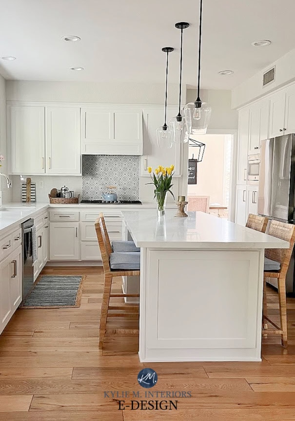 Rattan island stools, blue accents in white kitchen. Cabinets Sherwin Williams Pure White, walls BEnjamin MOore Classic Gray, subway tile, stainless steel. Kylie M Edesign