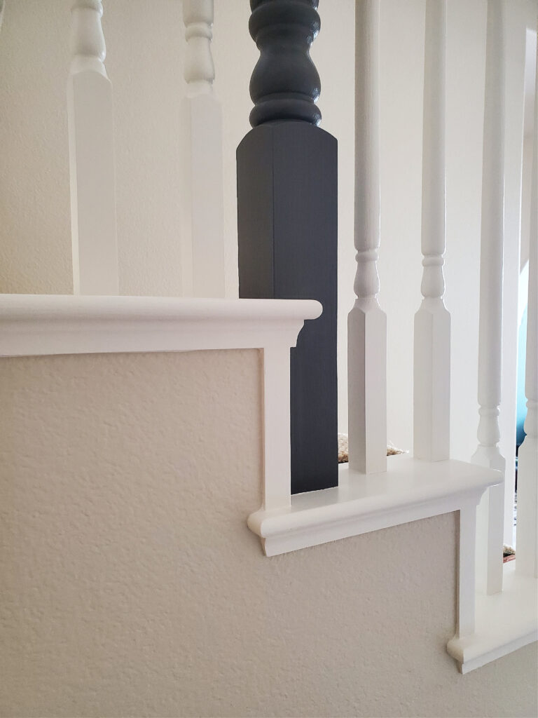 Sherwin Williams Natural Linen 25 percent darker with white trim and black stair railing. Kylie M Edesign, color consulting expert