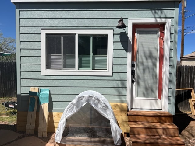 Sherwin Williams Silvermist painted blue green exterior paint color with coral, orange door samples. Kylie M Color consulting online