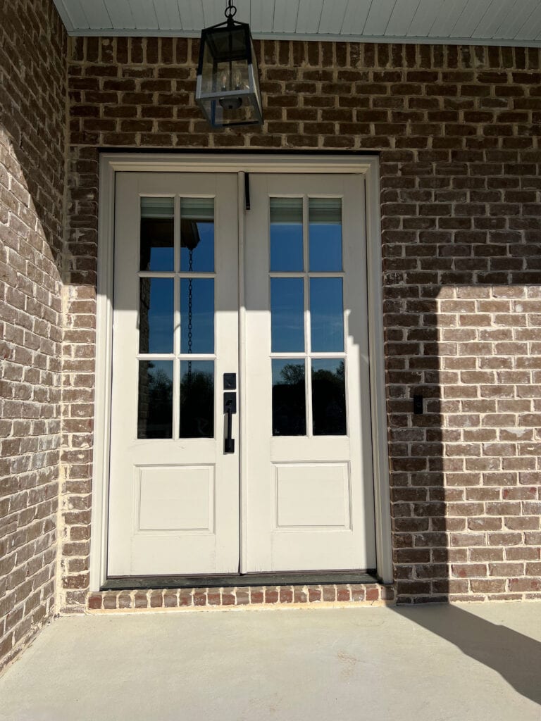 Benjamin Moore Edgecomb Gray front door with brown burgundy violet red brick house