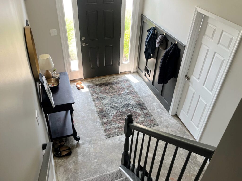 Benjamin Moore Edgecomb Gray lighter, Sherwin Williams Urbane Bronze board and batten with hooks in entryway foyer and inside of front door, linoleum vinyl floor, home decor