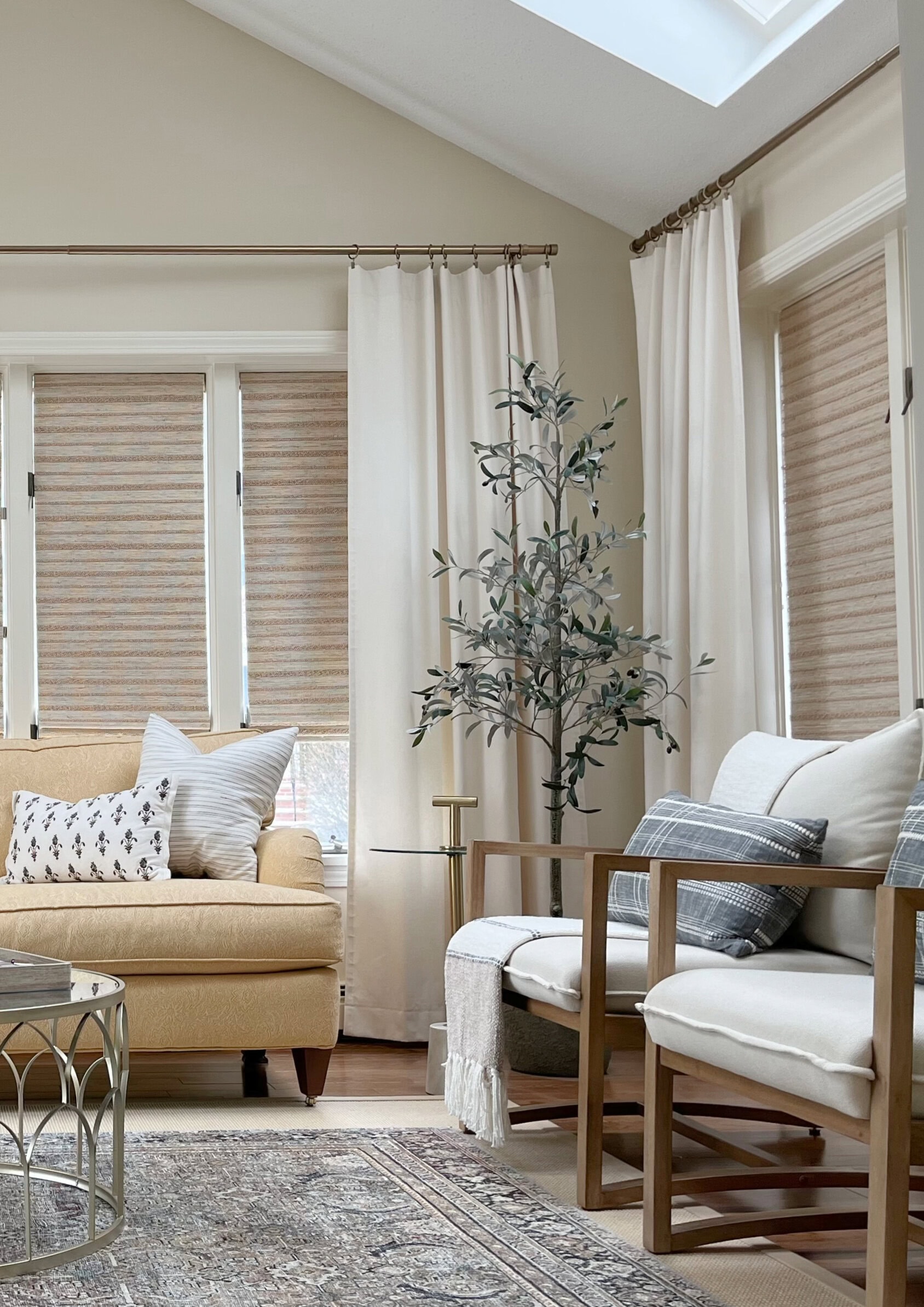 Benjamin Moore Natural Wicker in sunroom. Best cream paint color, off white chairs, yellow sofa.