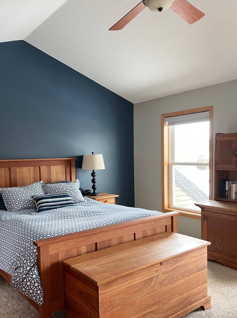 Benjamin Moore Newburyport Blue on accent wall in bedroom, Jogging Path side walls with orange stained wood trim and cherry furniture
