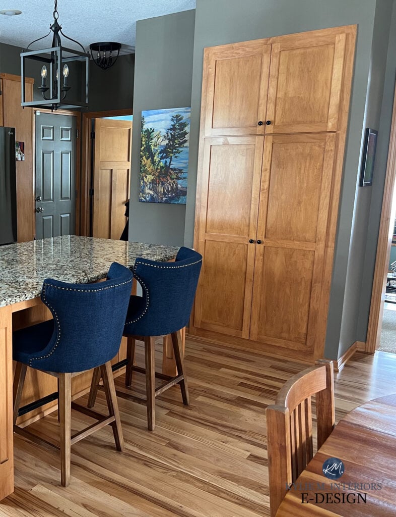 Benjamin Moore Texas Leather in kitchen with orange stain wood cabinets floor, granite countertop, greige green brown blend paint colors.