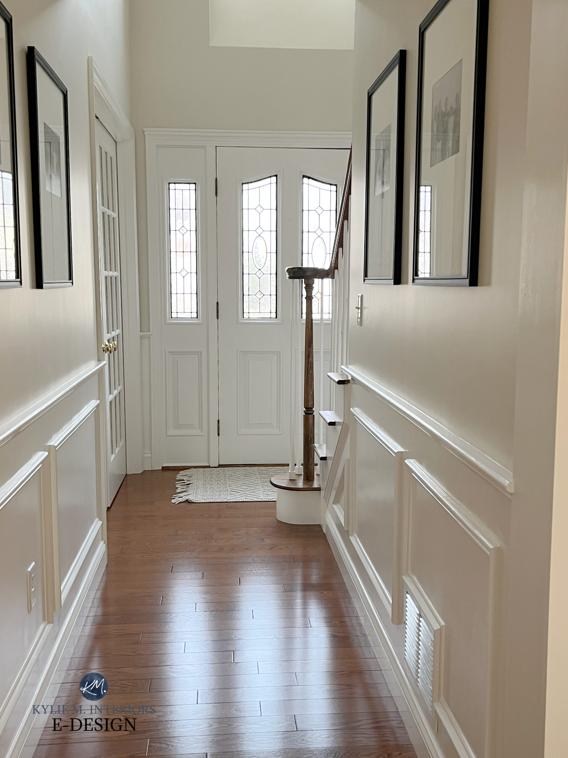 Hallway, front door, entryway in Benjamin MOore Ballet White with White Dove trim, popular warm off white paint color with red stain oak wood floor