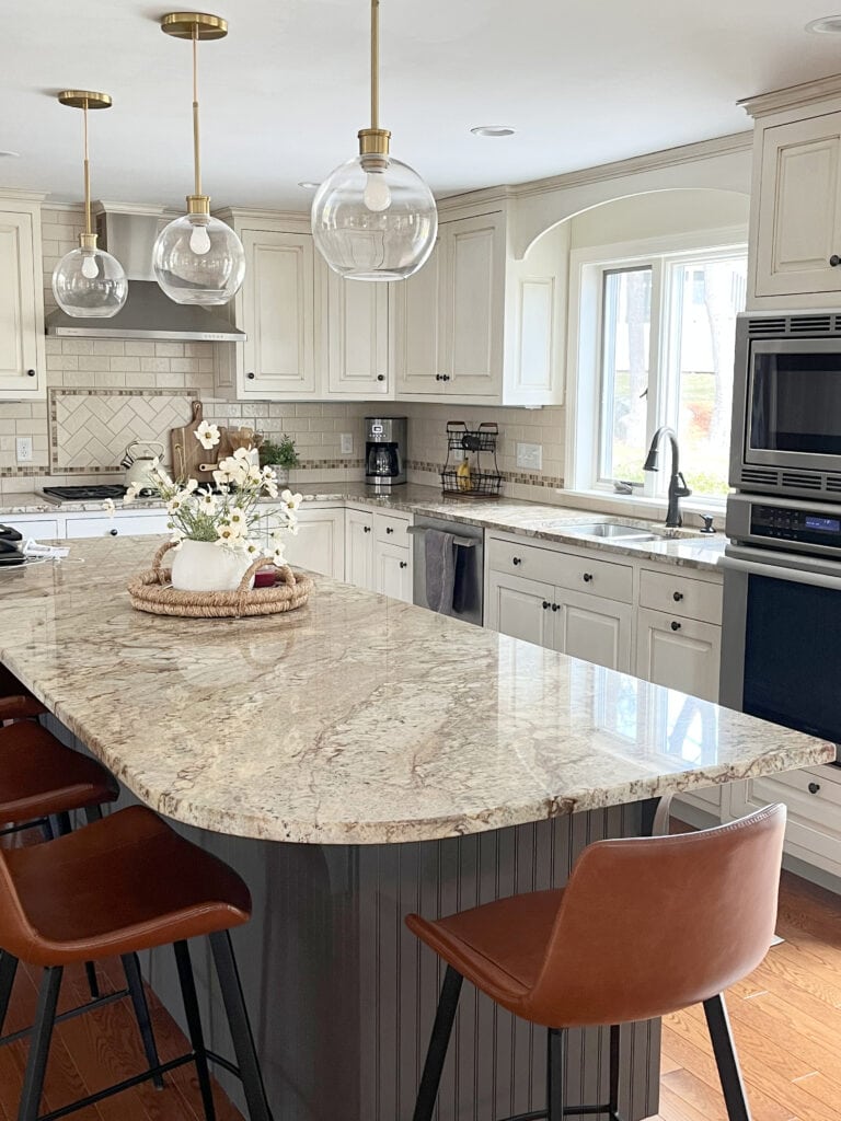 Kitchen cream painted and glazed cabinets, warm cream and gold granite countertop, cream subway tile backsplash, dark greige painted island, Sherwin Williams,