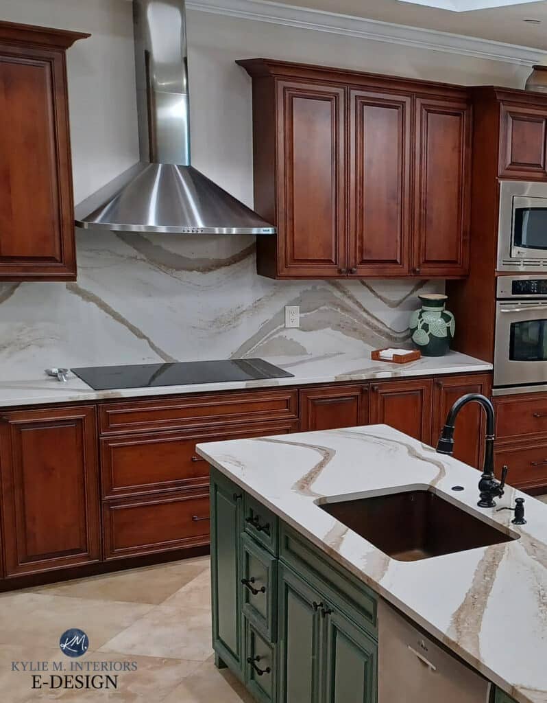 Sherwin Williams Accessible Beige on walls, lightened. Painted green kitchen island and cherry wood cabinets, similar to Sherwin Williasm Rock Bottom or darkened Basil. Cambria Brittanica Gold soft white quartz countertop. Kylie M Consulting
