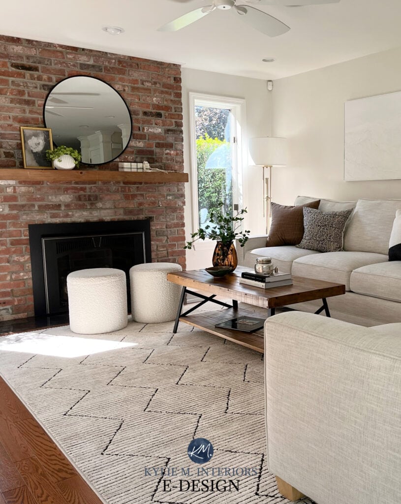Red, pink, orange brick fireplace, wood mantel, greige taupe warm gray walls, Sherwin Williams Egret White, home decor. Sofa. Kylie M Online paint color consulting expert