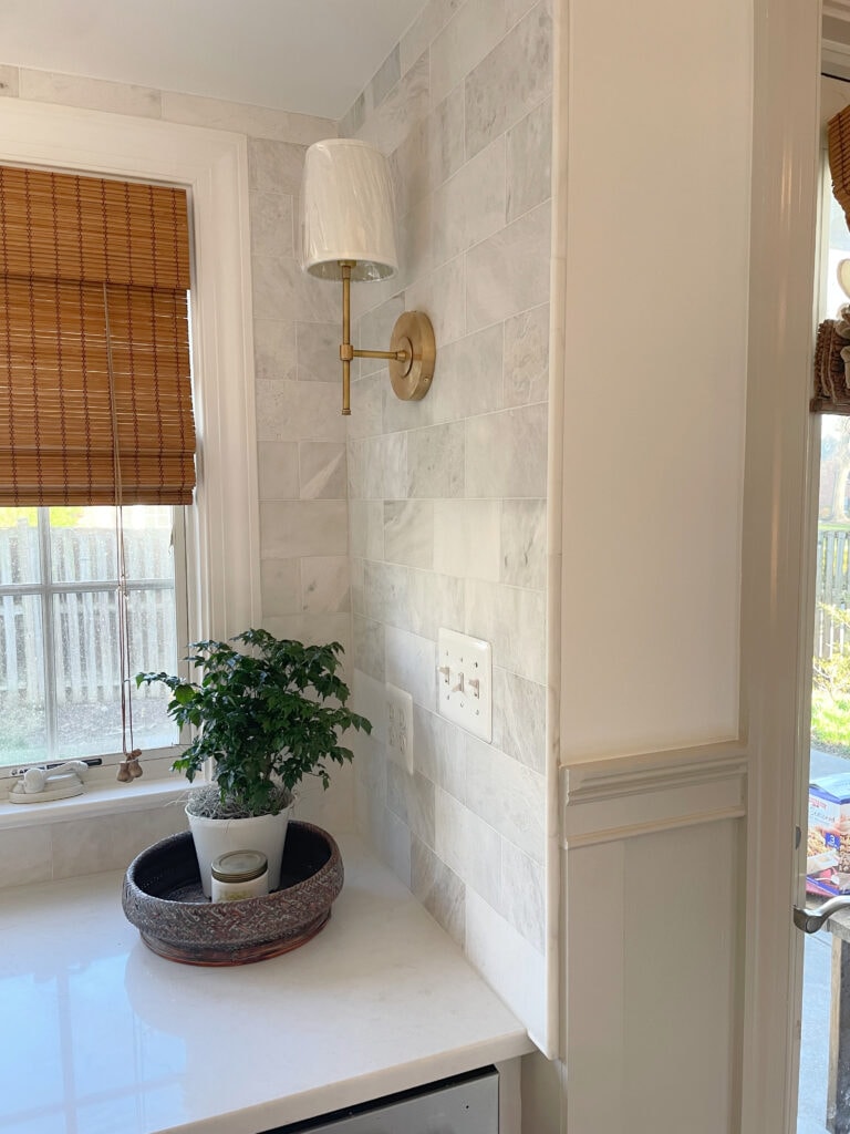 Sherwin Williams Agreeable Gray painted trim and board and batten, Chantilly Lace walls, full wall tile in marble subway tile, MSI MIRAGGIO DUO white quartz. Kylie M INteriors and Truley Home
