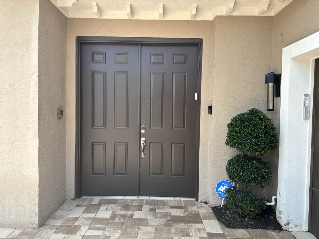 Sherwin Williams Threshold Taupe exterior stucco paint color, beige stone and dark greige front door