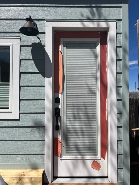 Silvermist exterior blue green paint color on studio with white trim. Kylie M Online paint color consulting client photo