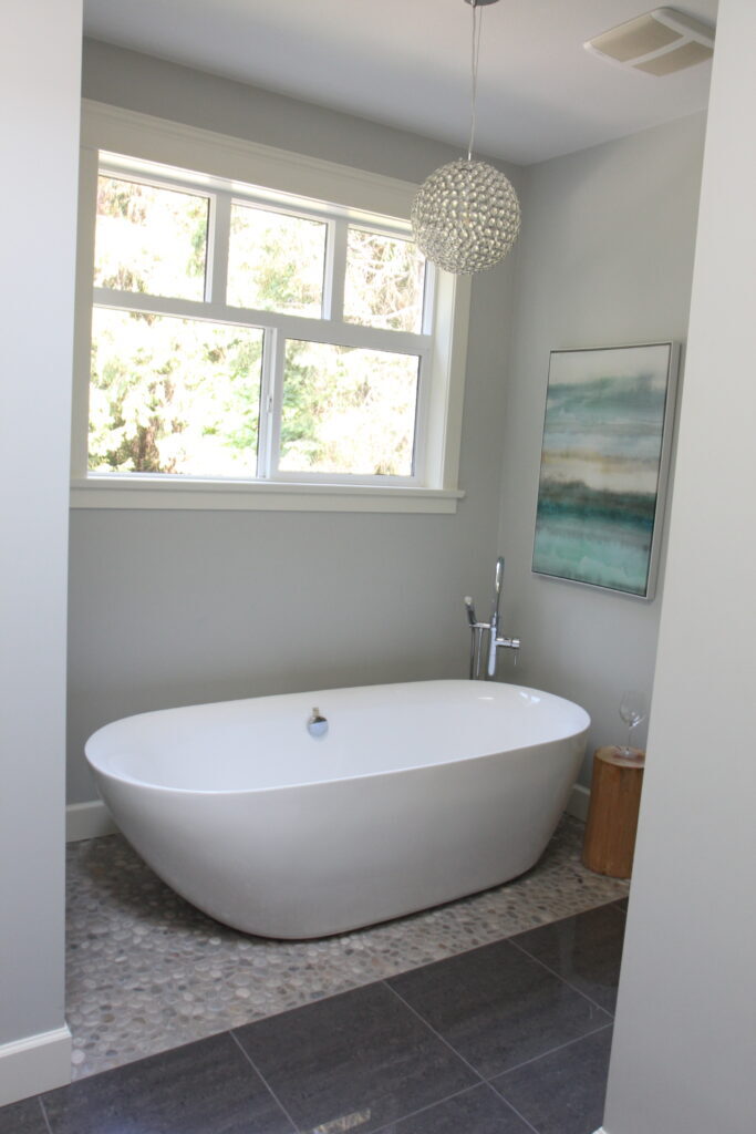 Benjamin Moore Wickham Gray, north facing bathroom, pebble rock floor, dark gray floor tile, freestanding tub, warm up a gray room
