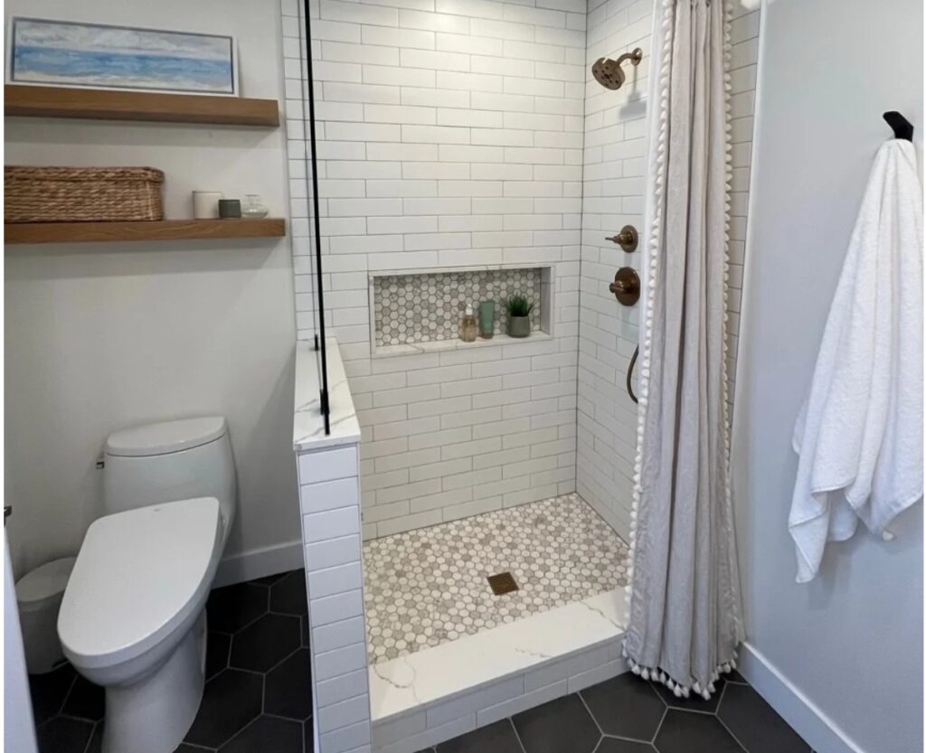 Sherwin Williams Alabaster in a bathroom with small walk in shower with curtain, subway tile on shower walls
