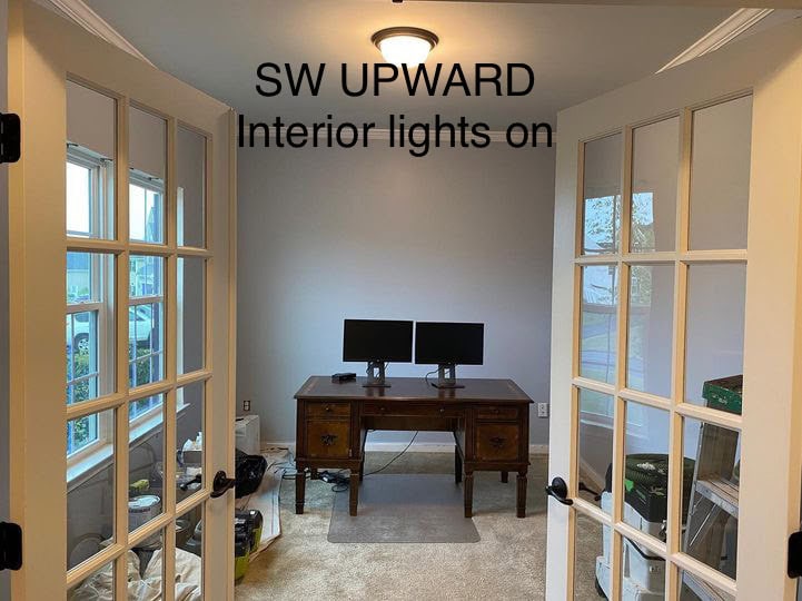 Sherwin Williams best blue paint color, blue-gray, Upward, COTY 2024. in home office with lights on and beige carpet.