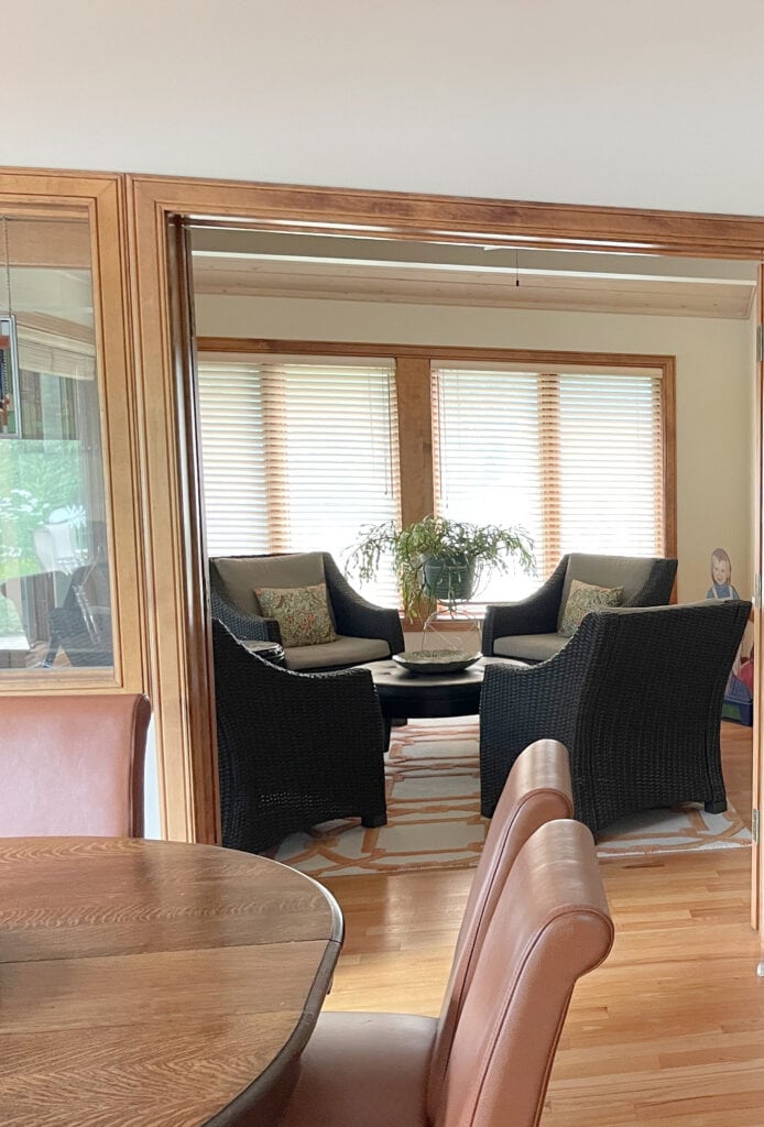 Benjamin Moore Muslin on the walls with cherry wood, stained trim, and wood flooring