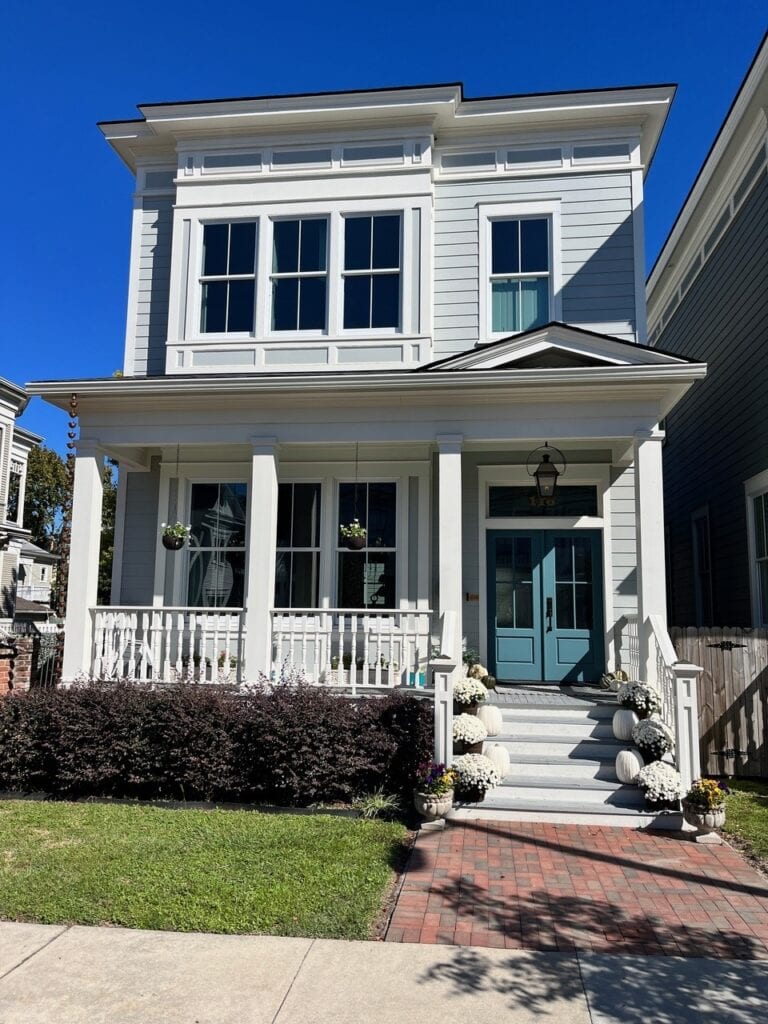 Front door painted medium blue, blue-green, Benjamin Moore Bella Blue, exterior gray siding, Half Moon Crest, front porch, white trim. Kylie M Edesign