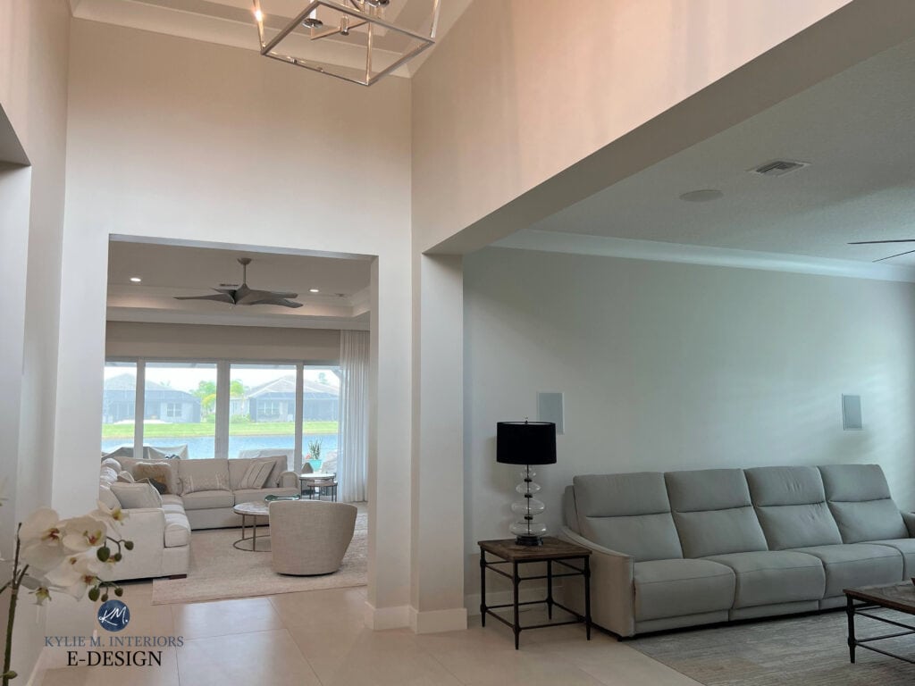 Sherwin Williams Aesthetic White in open layout entryway, living room, beige floor tile, vaulted ceiling. Kylie M INteriors