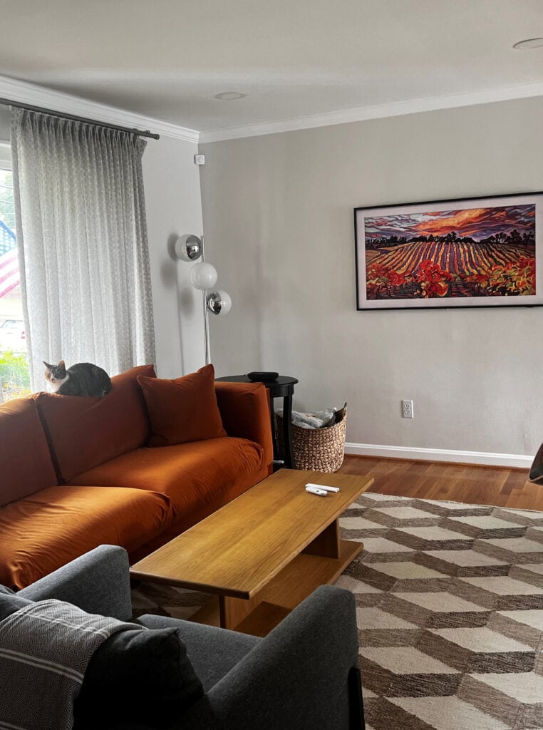 Sherwin Williams Heron Plume, best off white warm gray taupe paint color. Orange sofa. Kylie M ONline paint color consultant