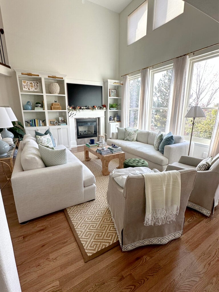 Sherwin Williams Greek Villa on walls, Benjamin Moore Chantilly Lace trim, built-ins, oak wood floor, living room furniture, home decor, accent colors.