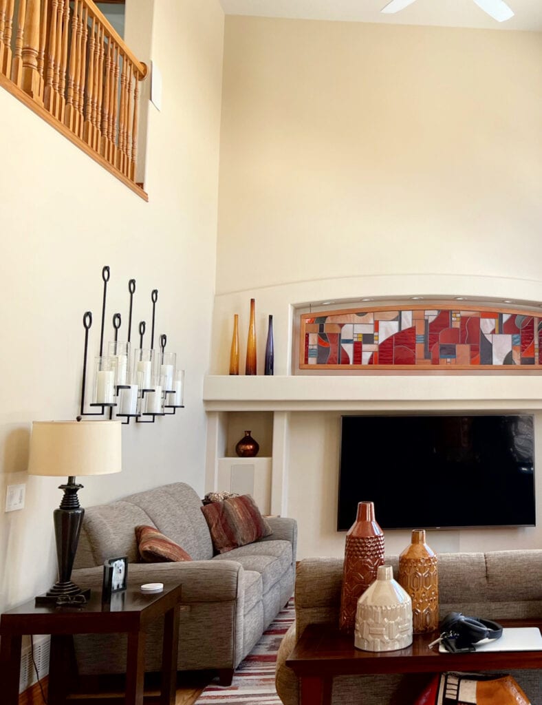 Benjamin Moore Alpaca, warm beige paint color for a room with a high ceiling. alcove above tv and warm, Tuscan style home decor