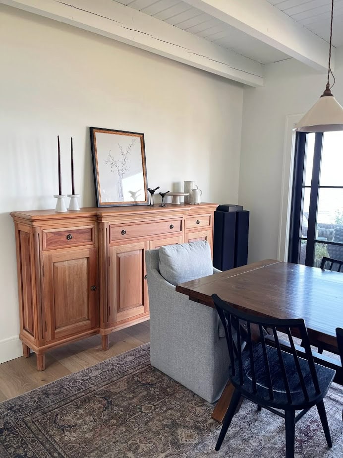 Benjamin Moore Simply White warm white on north-facing walls and ceiling beams in dining room.