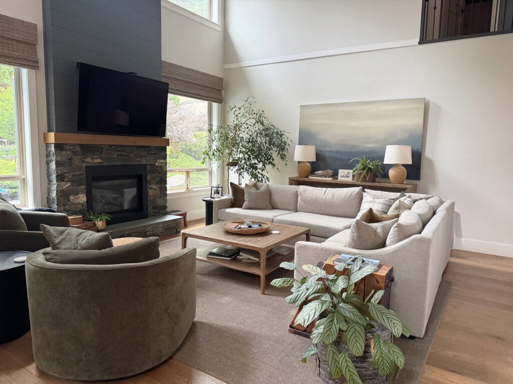 Living room with high, vaulted ceiling, Sherwin Williams Aesthetic White walls, Foggy Day shiplap fireplace, faux bamboo shades-wooden over windows, north facing light