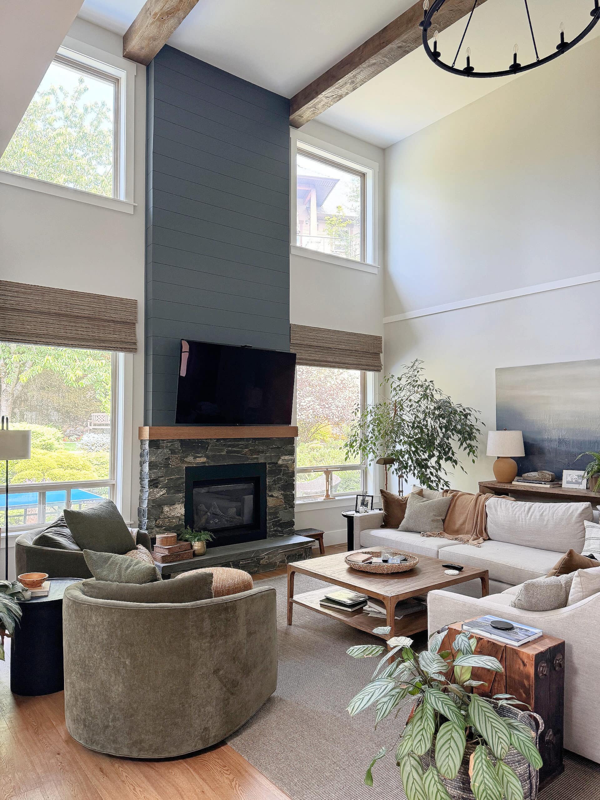 Sherwin Wiliams Aesthetic White in living room with high, vaulted ceiling and shiplap and K2 stone fireplace, sectional and pottery barn green accent chairs. North facing (2)